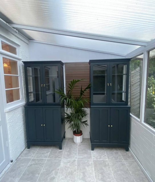 Decorated conservatory with contrasting painted display cabinets