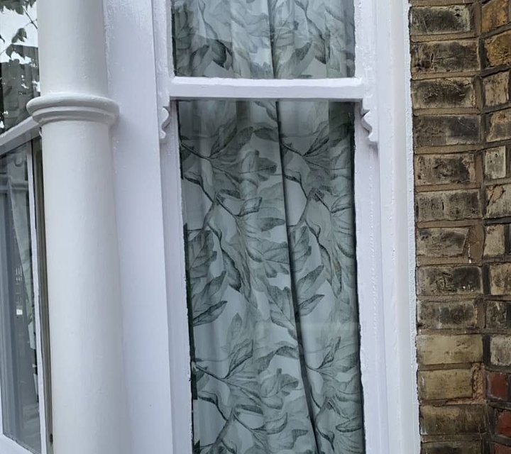 White-painted bay-window frame and exterior woodwork