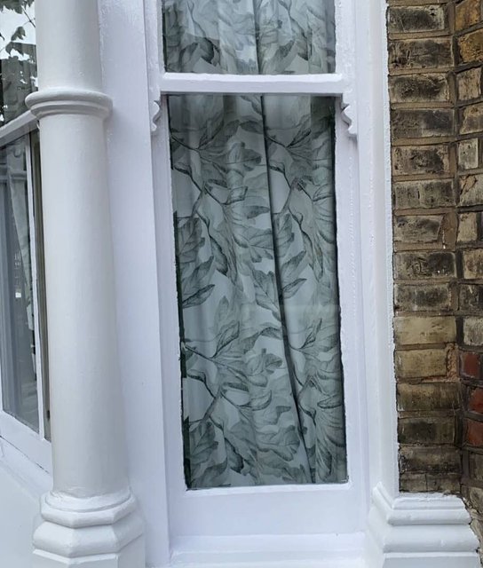 White-painted bay-window frame and exterior woodwork