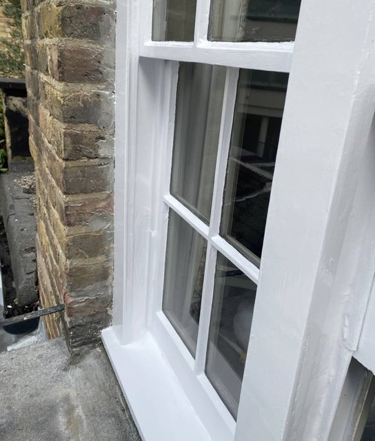 Freshly painted white timber sash-window frame