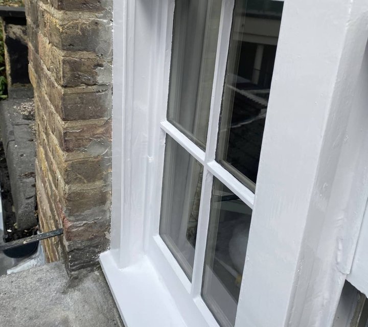 Freshly painted white timber sash-window frame